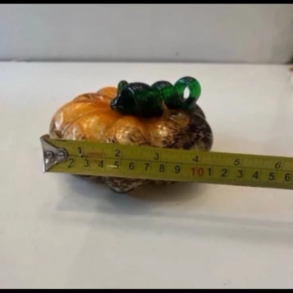 Orange and brown glass pumpkin with green stem
